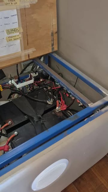 A 12 volt install inside a boat hatch, batteries and wiring loom laid out and fused.